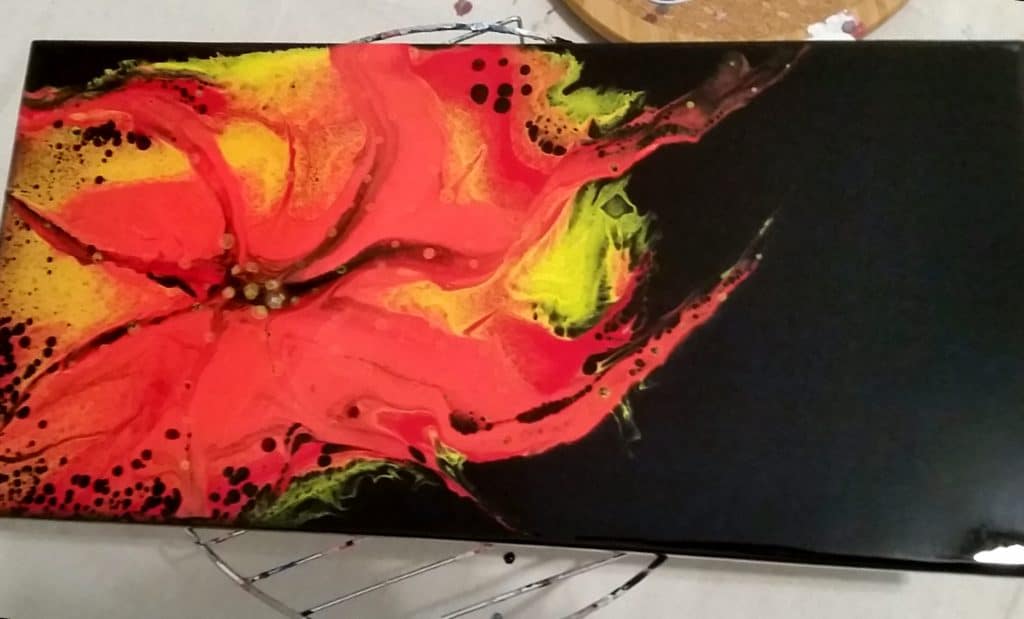 finished acrylic pour painting yellow black red and dots